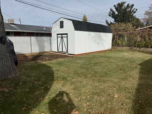 View of outdoor structure with a lawn