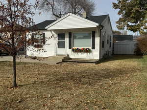 Bungalow-style house featuring a front lawn and central air condition unit