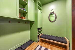 Mudroom with light hardwood / wood-style floors