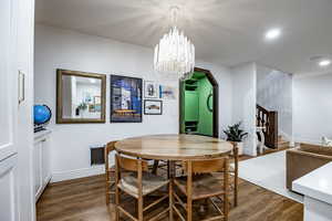 Dining room featuring a chandelier and dark hardwood / wood-style floors