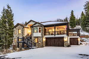 View of front of house with a balcony and a garage