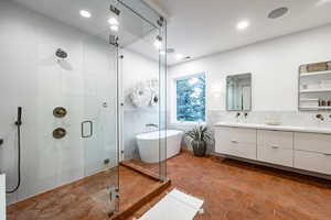 Bathroom with decorative backsplash, vanity, separate shower and tub, and tile patterned flooring