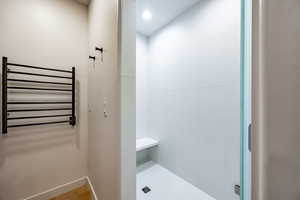 Bathroom with radiator heating unit and tile patterned floors