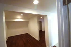 Basement with dark hardwood / wood-style flooring