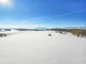 Yard covered in snow with a mountain view