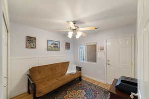 Living room featuring light wood-type flooring and ceiling fan