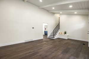 Interior space featuring dark hardwood / wood-style flooring, lofted ceiling with beams, and wood ceiling