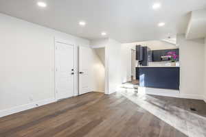 Unfurnished living room with dark hardwood / wood-style flooring