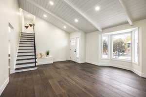 Entrance foyer featuring wood ceiling, beamed ceiling, dark wood-type flooring, and high vaulted ceiling