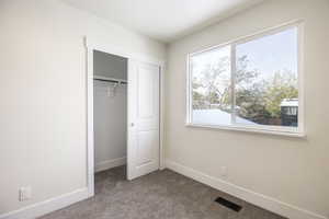 Unfurnished bedroom with a closet and carpet floors