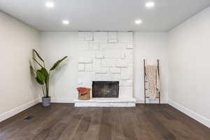 Interior details with a fireplace and wood-type flooring