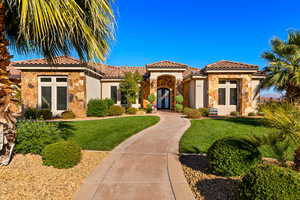 Mediterranean / spanish-style home with a front yard