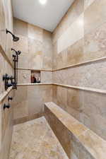 Bathroom with a tile shower and tile walls