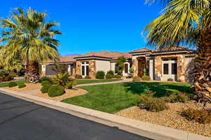 Mediterranean / spanish-style home with a front yard