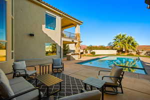 View of swimming pool featuring an outdoor kitchen and a patio