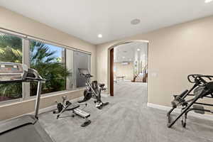 Workout room featuring light carpet and a wall mounted AC