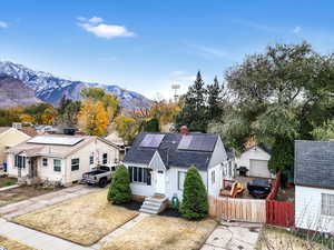 Exterior space featuring a mountain view, solar panels, an outbuilding, and a garage