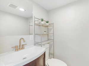 Bathroom featuring vanity and toilet