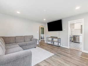 Living room featuring radiator and light hardwood / wood-style flooring