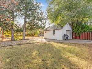 View of yard featuring an outbuilding and a garage