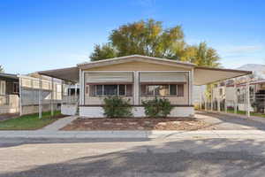 Manufactured / mobile home featuring a carport