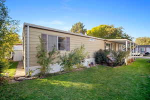 View of side of home with a yard