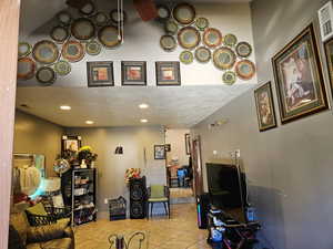 Living room featuring light tile patterned floors and a textured ceiling