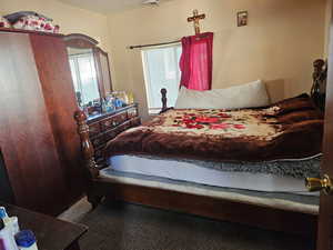 Carpeted bedroom featuring multiple windows