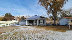 View of front facade with a mountain view and covered porch