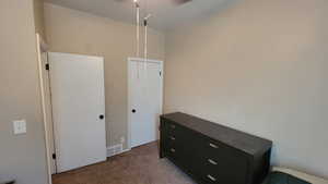 Bedroom featuring light colored carpet