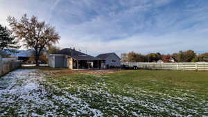 Back of house featuring a yard