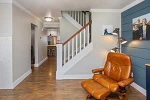 Interior space with crown molding and wood-type flooring