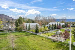 View of yard featuring a mountain view, a rural view, and a storage shed