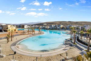 View of swimming pool with a mountain view