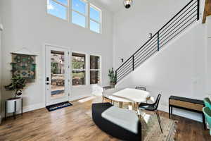 Dining area featuring a high ceiling and wood-type flooring