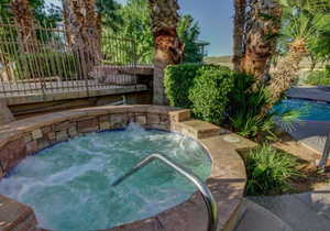 View of swimming pool with an in ground hot tub