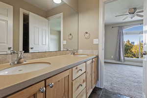 Bathroom featuring tile patterned flooring, vanity, and ceiling fan