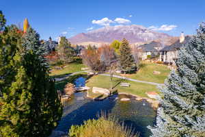 Birds eye view of property with a water and mountain view