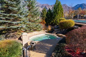 View of pool featuring a mountain view and an in ground hot tub