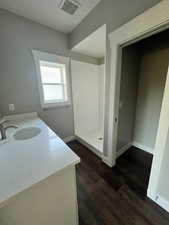 Example Bathroom with walk in shower, vanity, and hardwood / wood-style flooring