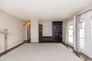 Unfurnished room featuring dark wood-type flooring