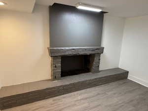 Room details with hardwood / wood-style floors and a brick fireplace