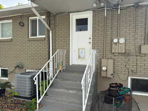 Doorway to property with cooling unit