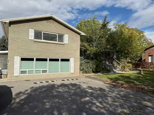 View of side of home with a garage