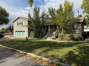 Obstructed view of property with a garage and a front yard