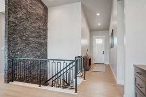 Corridor with light hardwood / wood-style flooring