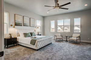 Carpeted bedroom featuring ceiling fan