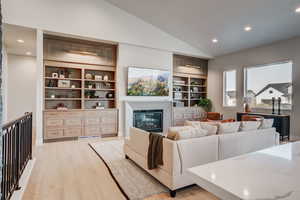 Living room with lofted ceiling and light wood-type flooring