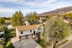 View of front of house with a mountain view and a garage