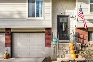 View of exterior entry with a garage